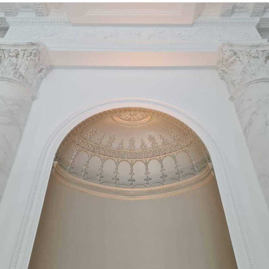 Beautiful faux marble columns along with this metallic glazed niche in the grand reception room of this amazing home.